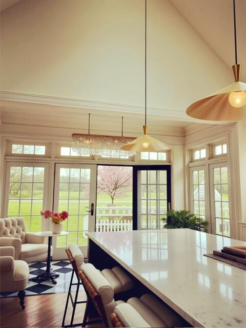 1 Forest St, Dover-Foxcroft, ME 04426 - kitchen with high vaulted ceiling, dark wood-type flooring, and a kitchen bar