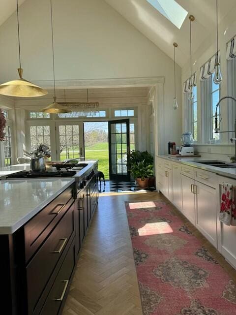 1 Forest St, Dover-Foxcroft, ME 04426 - kitchen with a skylight, plenty of natural light, light countertops, pendant lighting, and high vaulted ceiling
