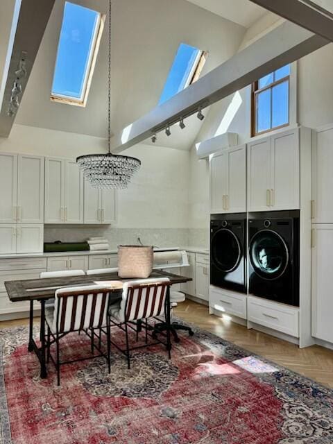 1 Forest St, Dover-Foxcroft, ME 04426 - washroom featuring separate washer and dryer, a skylight, rail lighting, a high ceiling, and cabinet space