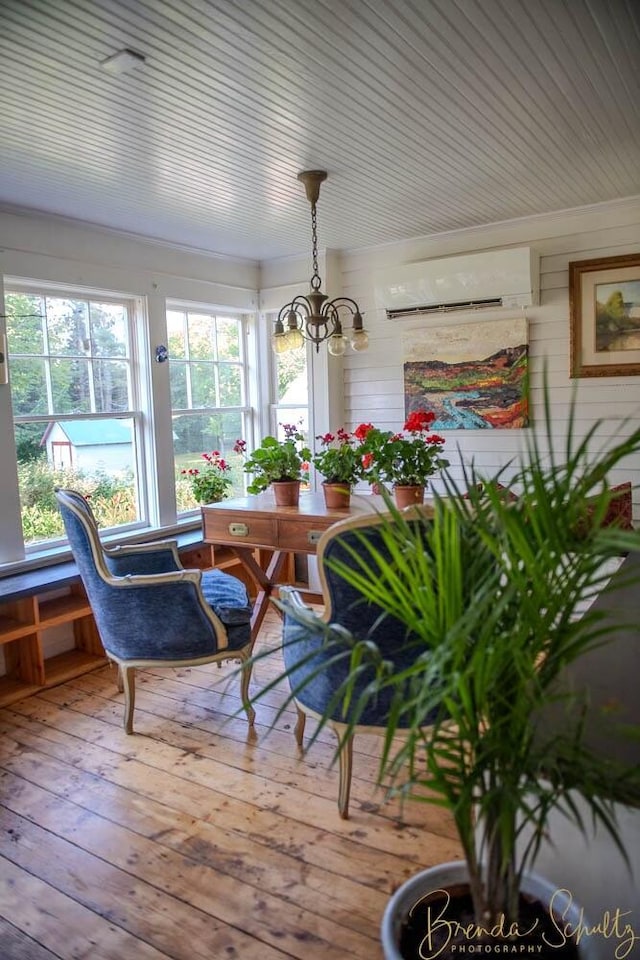 1 Forest St, Dover-Foxcroft, ME 04426 - sunroom / solarium featuring a wall unit AC, a chandelier, and healthy amount of natural light