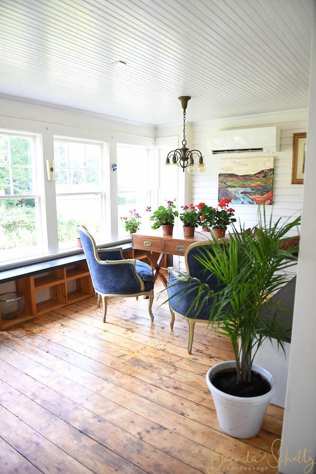 1 Forest St, Dover-Foxcroft, ME 04426 - sunroom featuring a wall unit AC and a chandelier