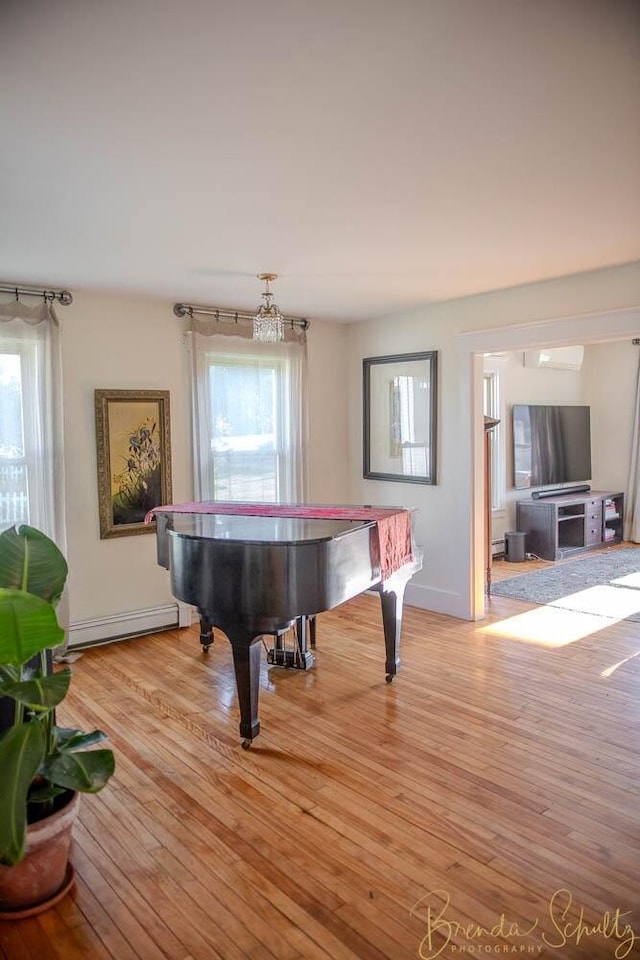 1 Forest St, Dover-Foxcroft, ME 04426 - game room featuring a baseboard heating unit, healthy amount of natural light, and light wood-style floors