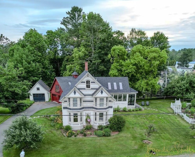 1 Forest St, Dover-Foxcroft, ME 04426 - view of front of house with an outbuilding, a chimney, a detached garage, asphalt driveway, and a shingled roof