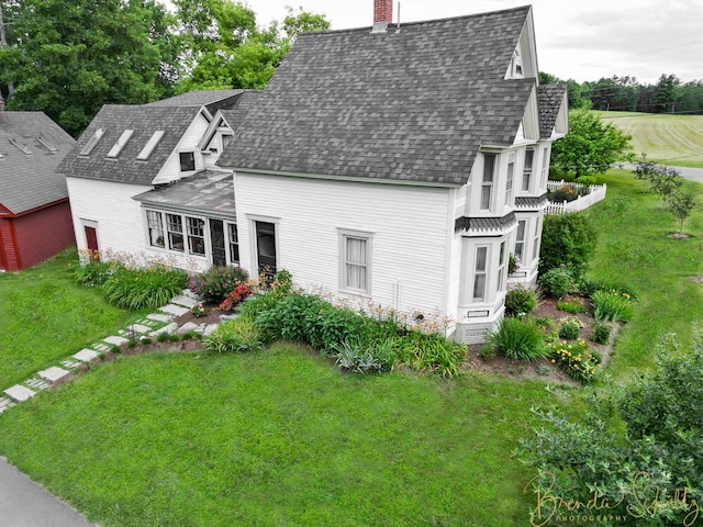 1 Forest St, Dover-Foxcroft, ME 04426 - view of front of house with a chimney, a shingled roof, and a front yard