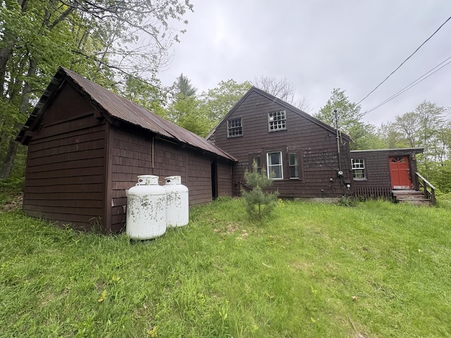 15 Sawyer Ln, Sanford, ME 04083 - rear view of property featuring an outbuilding, a lawn, and entry steps