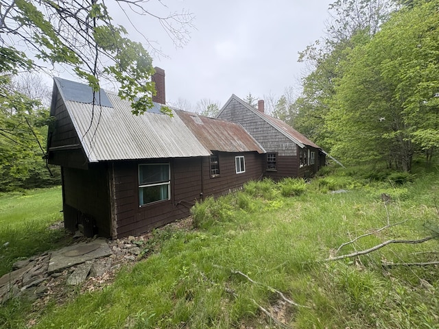 15 Sawyer Ln, Sanford, ME 04083 - view of side of property featuring a chimney and metal roof