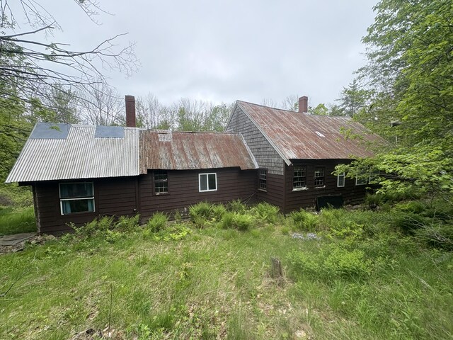 15 Sawyer Ln, Sanford, ME 04083 - view of side of property with a chimney and metal roof