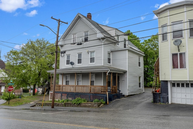 28 Bartlett St, Lewiston, ME 04240 - view of front of property with covered porch, a chimney, and driveway