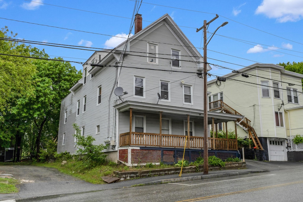 28 Bartlett St, Lewiston, ME 04240 - view of front of home with covered porch, a chimney, and asphalt driveway