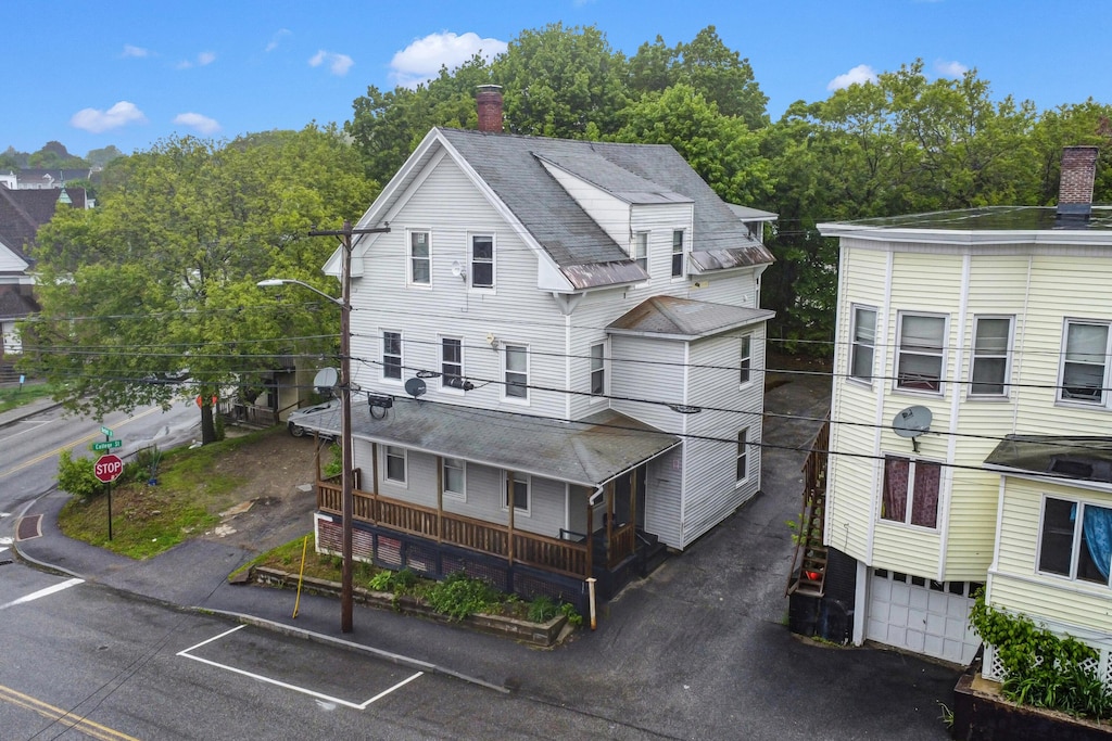 28 Bartlett St, Lewiston, ME 04240 - view of front of property with a chimney and a shingled roof