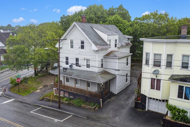28 Bartlett St, Lewiston, ME 04240 - view of front of property with a chimney and a shingled roof
