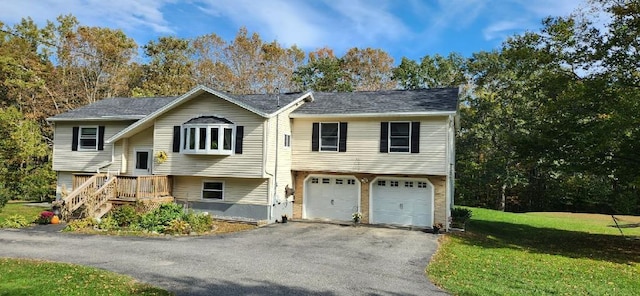 186 Clark Rd, Albion, ME 04910 - raised ranch with asphalt driveway, an attached garage, and a front yard