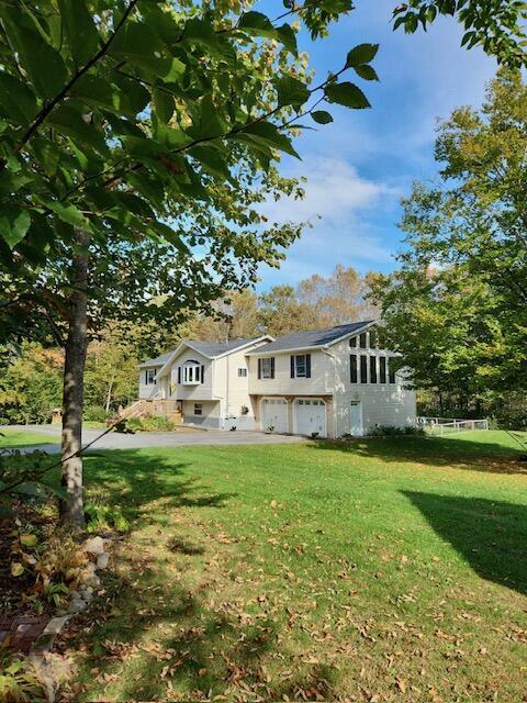 186 Clark Rd, Albion, ME 04910 - view of front of home featuring a garage and a front lawn