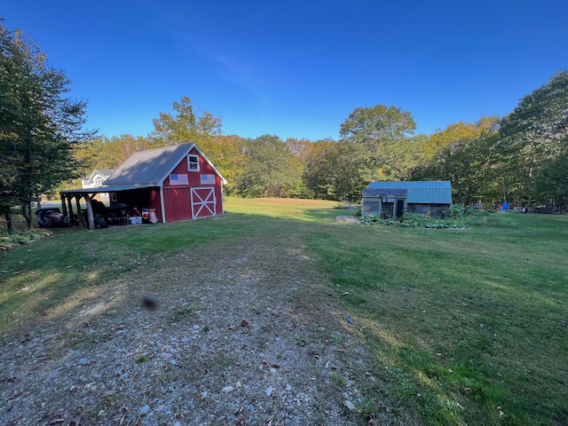 186 Clark Rd, Albion, ME 04910 - view of grassy yard with a barn and an outbuilding