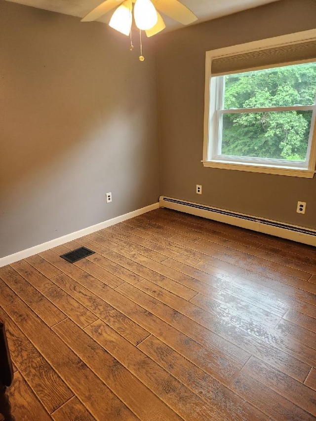 186 Clark Rd, Albion, ME 04910 - spare room featuring dark wood-style flooring, baseboard heating, ceiling fan, and baseboards