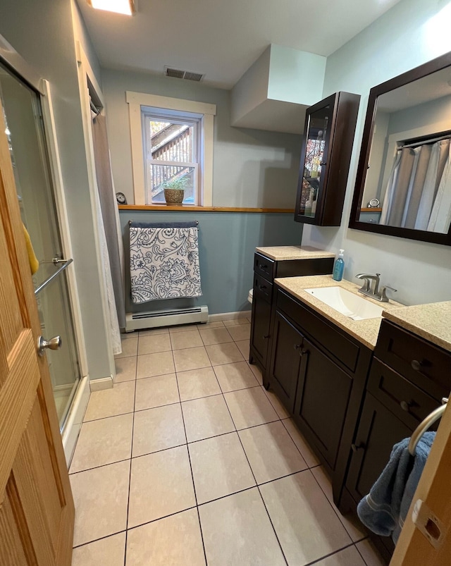 186 Clark Rd, Albion, ME 04910 - bathroom with tile patterned flooring, a shower with door, vanity, baseboard heating, and baseboards