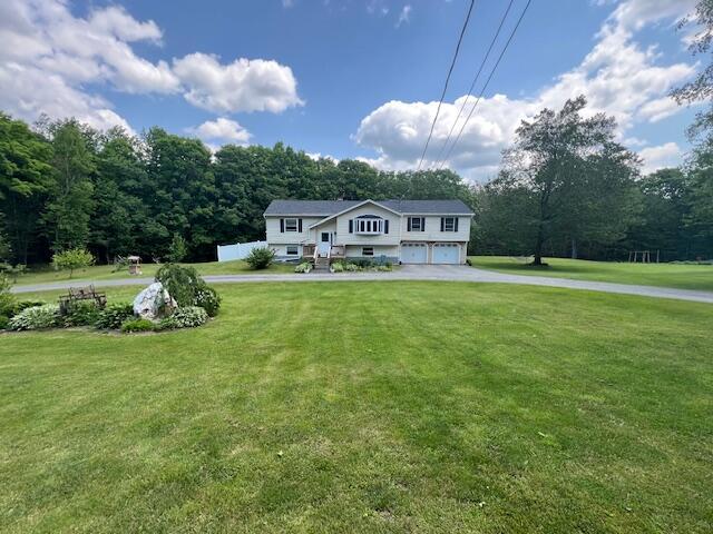 186 Clark Rd, Albion, ME 04910 - split foyer home featuring an attached garage, concrete driveway, and a front yard