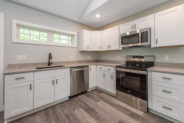 160 Maplewood Dr, Naples, ME 04055 - kitchen with stainless steel appliances, a sink, dark wood-type flooring, white cabinetry, and recessed lighting