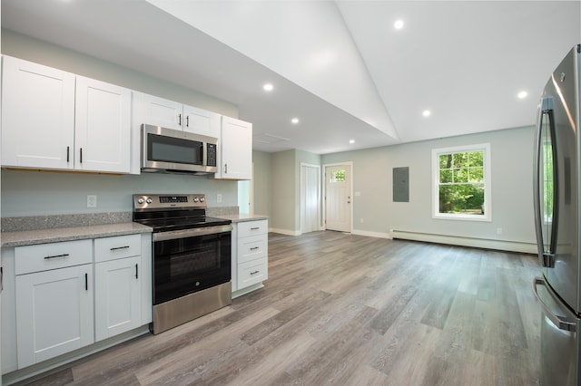 160 Maplewood Dr, Naples, ME 04055 - kitchen featuring stainless steel appliances, a baseboard heating unit, light wood finished floors, white cabinetry, and vaulted ceiling