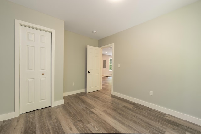 160 Maplewood Dr, Naples, ME 04055 - unfurnished bedroom featuring wood finished floors, baseboards, and baseboard heating