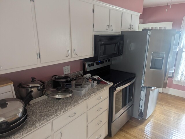 35 Brimmer St, Brewer, ME 04412 - kitchen featuring stainless steel appliances, light wood finished floors, and white cabinetry