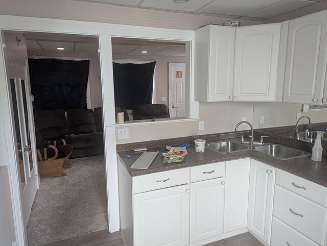 35 Brimmer St, Brewer, ME 04412 - kitchen with a sink, white cabinets, dark countertops, and carpet floors