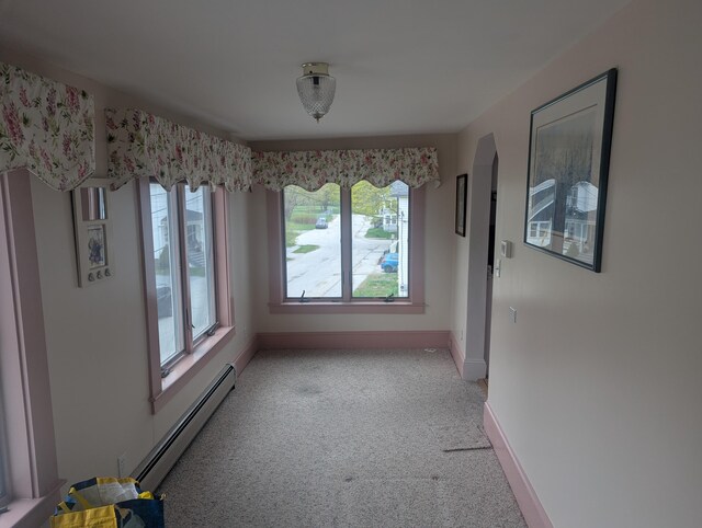 35 Brimmer St, Brewer, ME 04412 - unfurnished dining area featuring a baseboard heating unit, light colored carpet, plenty of natural light, and baseboards
