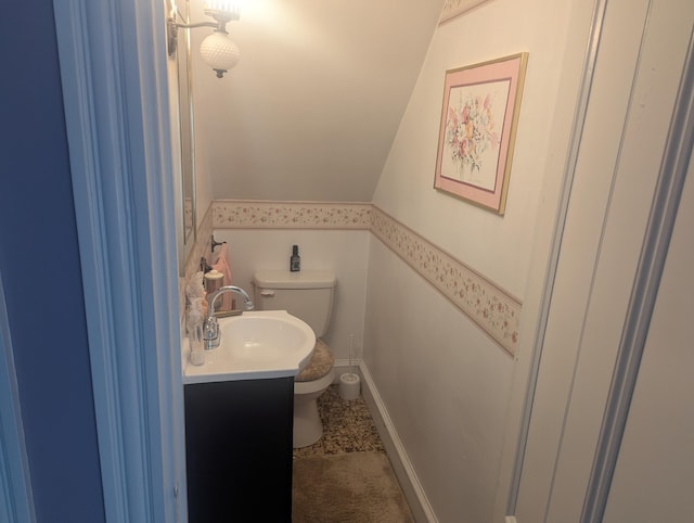 35 Brimmer St, Brewer, ME 04412 - bathroom featuring toilet, vaulted ceiling, and vanity