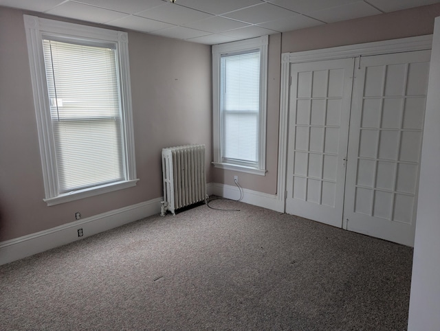 35 Brimmer St, Brewer, ME 04412 - unfurnished bedroom with radiator heating unit, carpet flooring, multiple windows, and baseboards