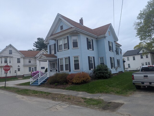 35 Brimmer St, Brewer, ME 04412 - view of front of property with a chimney, a front yard, and a shingled roof