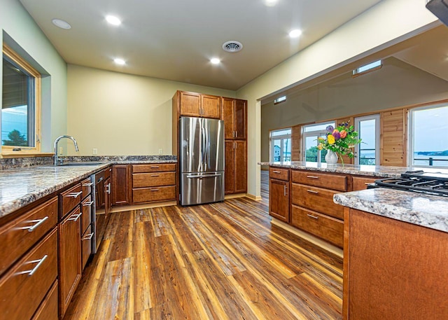 55 Diamond Point Rd, Lubec, ME 04652 - kitchen with stainless steel appliances, dark wood-style floors, brown cabinetry, light stone countertops, and recessed lighting