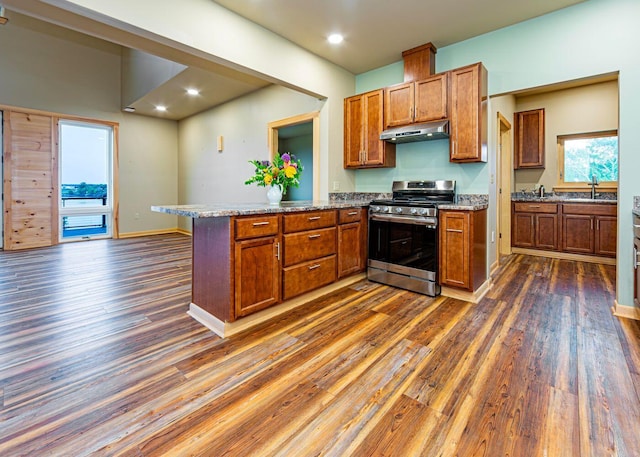 55 Diamond Point Rd, Lubec, ME 04652 - kitchen with stainless steel gas stove, under cabinet range hood, dark wood-style flooring, a peninsula, and recessed lighting