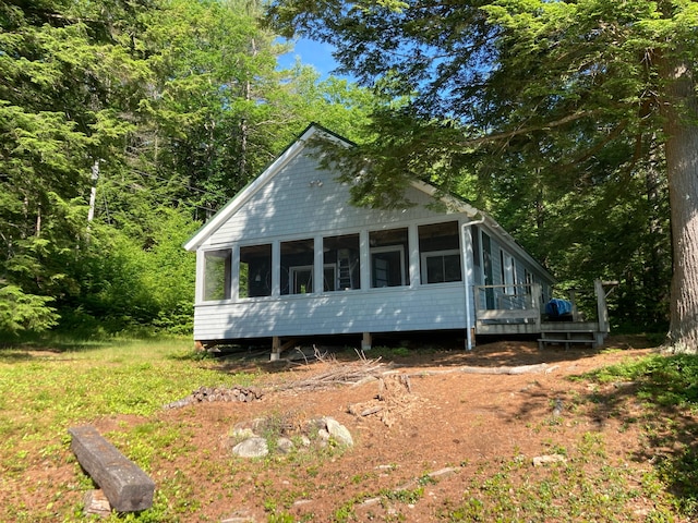 369 Narrow Gauge Trl, Hiram, ME 04041 - view of front of property with a sunroom and a forest view
