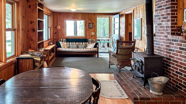 369 Narrow Gauge Trl, Hiram, ME 04041 - living room with a wood stove, wood finished floors, and wood walls