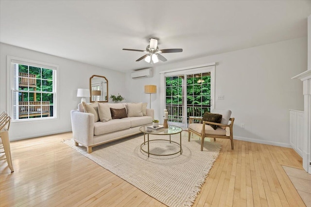 14 Woodside Dr Unit 3, Gorham, ME 04038 - living area with a wall unit AC, ceiling fan, light wood-type flooring, and plenty of natural light