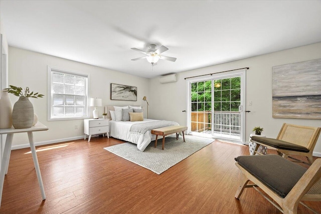 14 Woodside Dr Unit 3, Gorham, ME 04038 - bedroom featuring access to exterior, wood finished floors, a wall unit AC, and ceiling fan