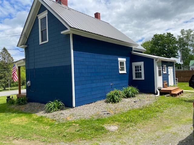 58 Main St, Sangerville, ME 04479 - view of side of home with a chimney and metal roof