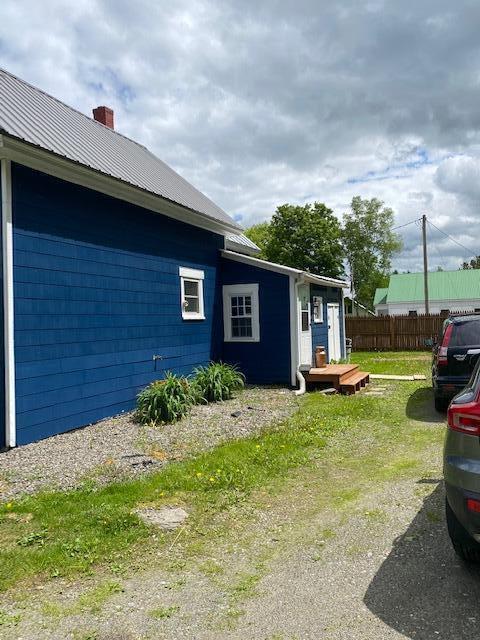58 Main St, Sangerville, ME 04479 - view of side of property with metal roof and a chimney