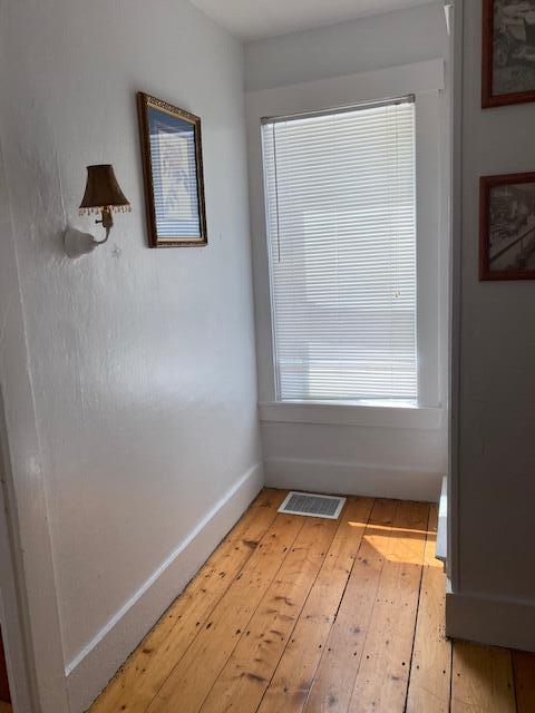58 Main St, Sangerville, ME 04479 - spare room with light wood-type flooring and baseboards