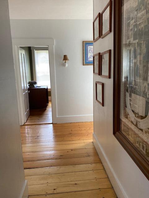 58 Main St, Sangerville, ME 04479 - hallway with light wood-type flooring and baseboards
