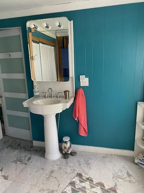 58 Main St, Sangerville, ME 04479 - bathroom with marble finish floors, baseboards, and a decorative wall