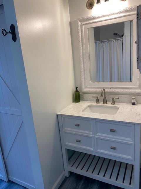 58 Main St, Sangerville, ME 04479 - full bath with vanity and wood finished floors