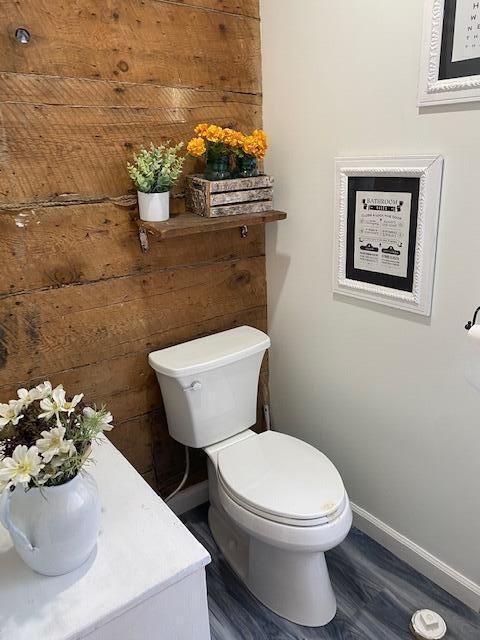 58 Main St, Sangerville, ME 04479 - bathroom featuring baseboards, toilet, wood finished floors, and vanity