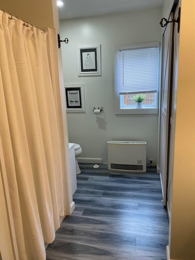 58 Main St, Sangerville, ME 04479 - full bath featuring toilet, wood finished floors, baseboards, and a shower with curtain