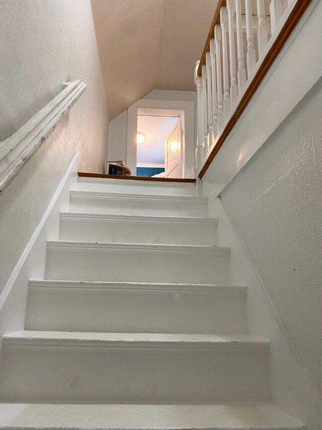 58 Main St, Sangerville, ME 04479 - stairs with vaulted ceiling and a textured wall