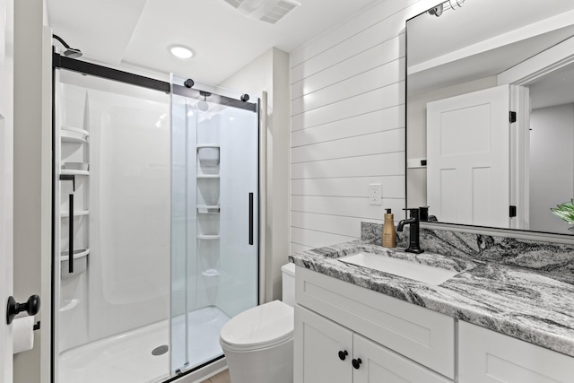 66 Old Dynamite Way, Gorham, ME 04038 - bathroom with vanity, a stall shower, wood walls, and toilet