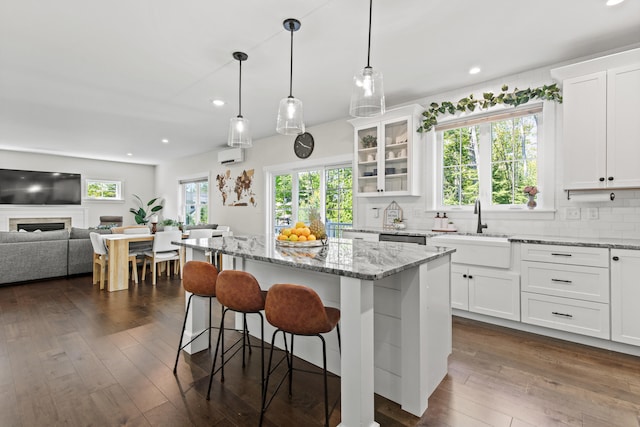66 Old Dynamite Way, Gorham, ME 04038 - kitchen with a sink, white cabinets, tasteful backsplash, a breakfast bar area, and recessed lighting