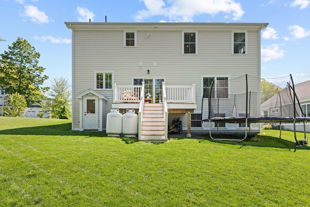66 Old Dynamite Way, Gorham, ME 04038 - back of property with a trampoline, a deck, a yard, and stairs