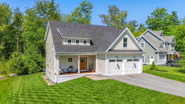 66 Old Dynamite Way, Gorham, ME 04038 - view of front facade with covered porch, driveway, a front lawn, and a shingled roof