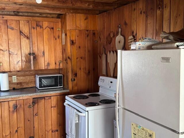 316 Ocean Ave, Wells, ME 04090 - kitchen with white appliances, brown cabinetry, and wood walls